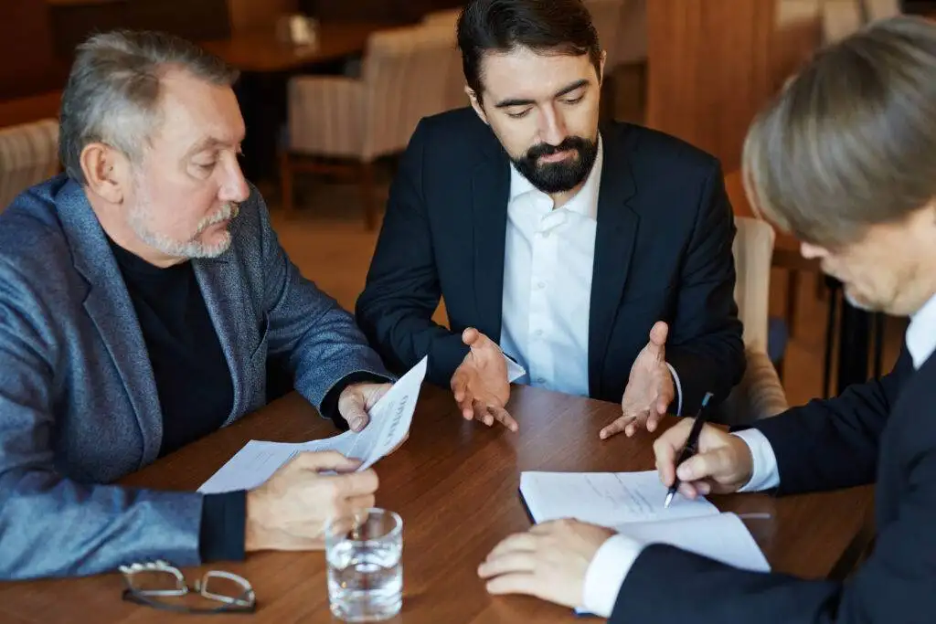 Businessman working hard on a laptop in a restaurant.