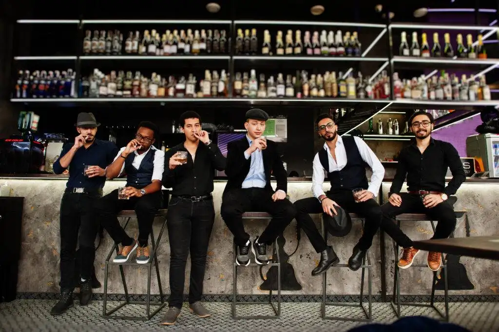 Group of retro well-dressed men dressed as gangsters spending time together.