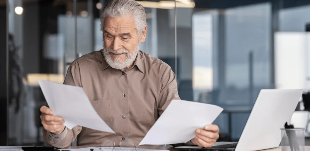 Retired Texas veteran reviewing legal documents about mesothelioma compensation