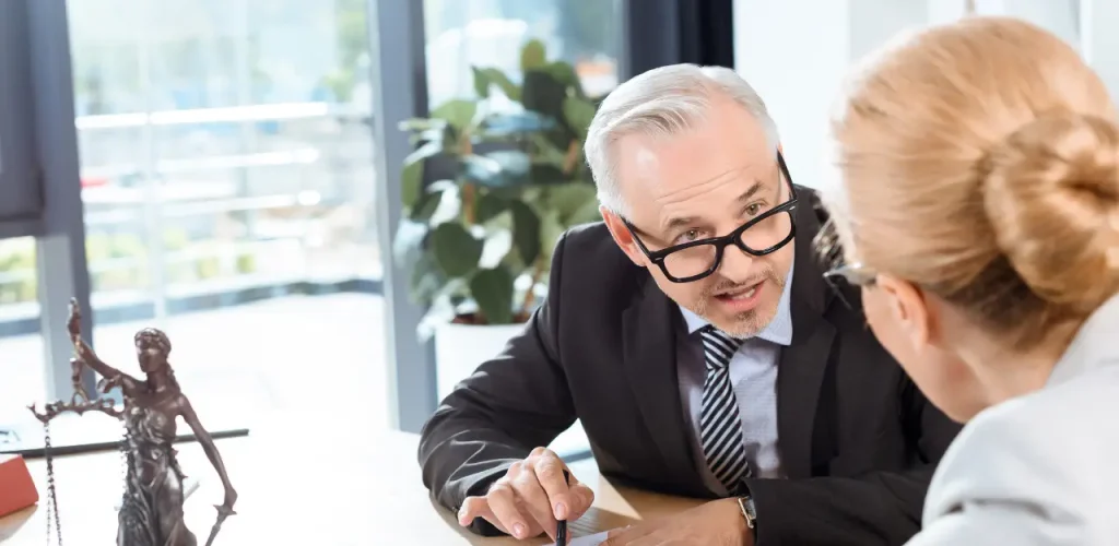 Lawyer meeting with client in office to discuss legal case
